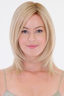 Woman in a shoulder length light blonde wig with feathered layers up front