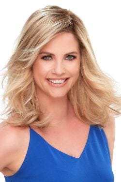Woman in a 12" light blonde semi-curly lace front hair topper with side bangs