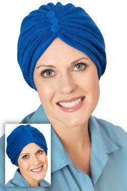 Women in blue terry cloth turban, show worn two ways for cancer patients