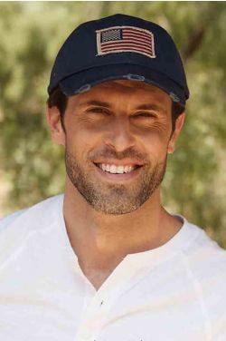 Cool man in navy distressed baseball cap with american flag patch on the front