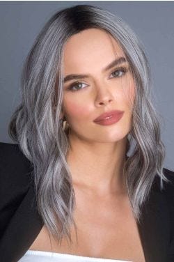 Woman in a past the shoulders dark grey wavy lace front wig