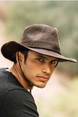 Man outdoors in distressed brown australian outback hat