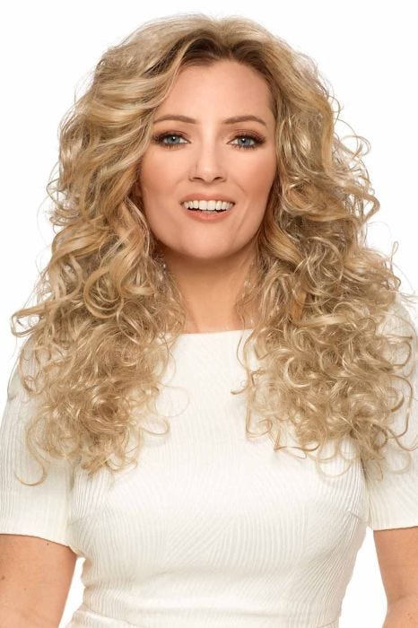Woman in an extra long curly layered warm blonde wig