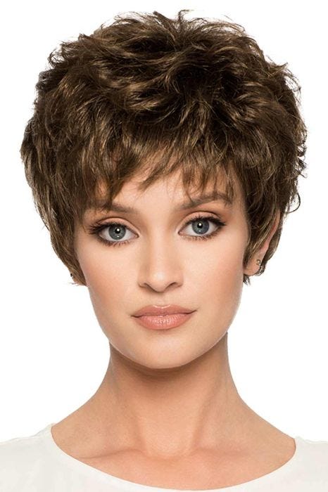 Woman in a long medium brown pixie wig with wispy bangs