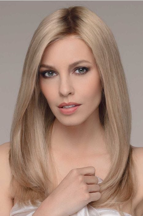 Woman in an extra long blonde blunt cut wig