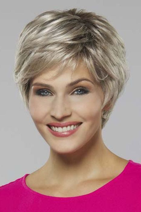 Woman in a platinum blonde long pixie wig with side bangs