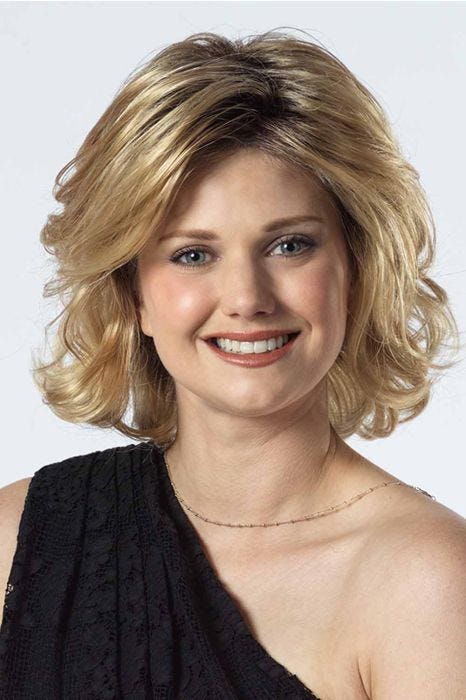 Woman in a shoulder length light blonde wavy lace front wig