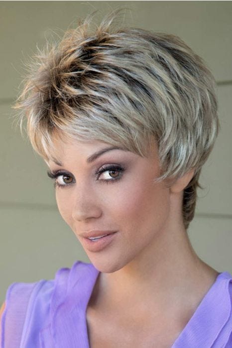 Woman in a choppy light brown pixie wig with fringe bangs