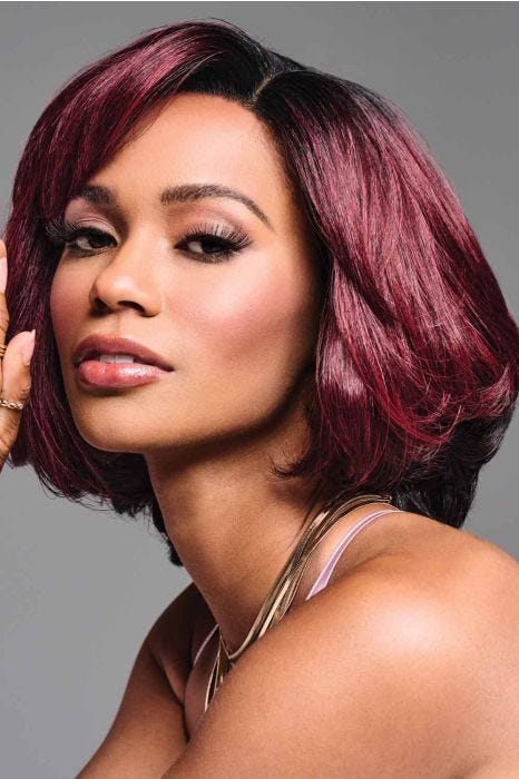African American woman in a past the chin burgundy rounded bob wig with side bangs