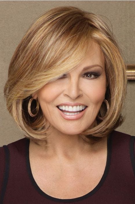 Raquel welch in a straight shoulder length light auburn rounded bob wig with long side bangs