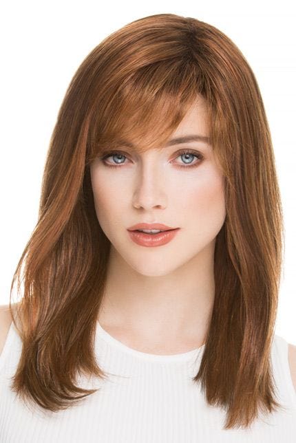 Woman in a past the shoulders medium auburn blunt cut wig with side bangs