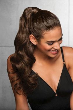 Woman in a 23" dark brown clip on curly ponytail attached to her hair