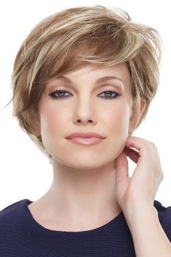 Woman in a long blonde and light brown pixie wig with side swept bangs