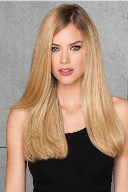 woman in 20" reddish blonde hair extensions attached to her hair
