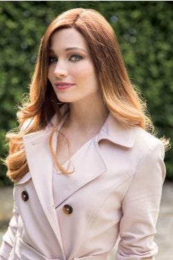 Woman in an extra long curly light auburn lace front wig