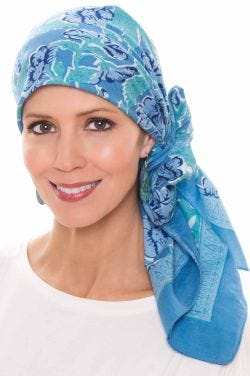 Woman in cotton floral head scarf in shades of blue for women with cancer
