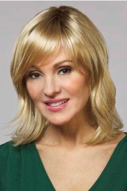Woman in a shoulder length red blonde wavy lace front wig with side bangs