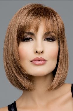 Woman in a shoulder length light brown bob wig with textured bangs