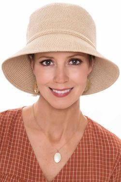 Middle aged woman in straw bucket hat for cancer patients