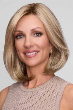 Woman in a shoulder length blonde blunt bob wig with long layers