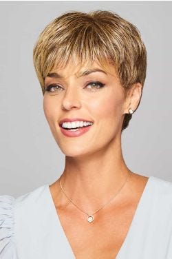 Short pixie wig with wispy bangs and layered texture in highlighted blonde with tapered nape