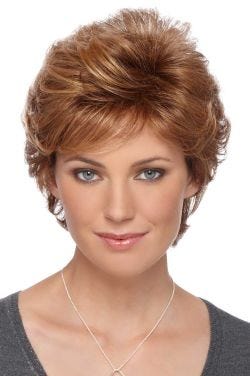 Woman in a short layered light auburn wig with side bangs