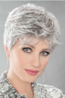 Woman in a light grey pixie wig with longer hair on top