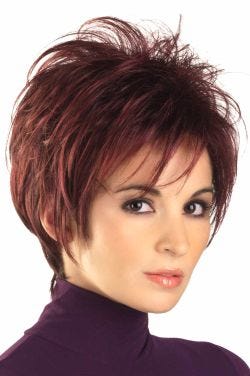 Woman in a spiky burgundy long pixie wig with wispy bangs