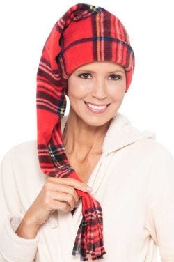 Woman in red plaid Christmas sleeping cap or stocking hat with long tail