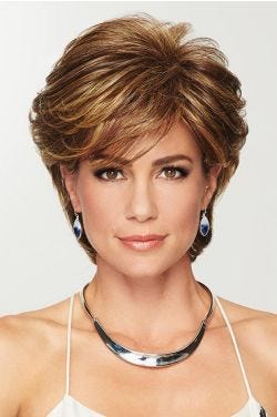 Woman in a textured medium brown pixie wig with longer layers on top