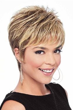 Woman in a layered blonde pixie wig with longer layers on top