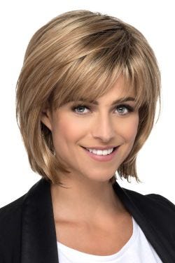 Woman in a shoulder length light auburn layered bob wig with fringe bangs