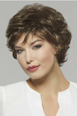 Woman in a medium length brown pixie wig with textured layering throughout