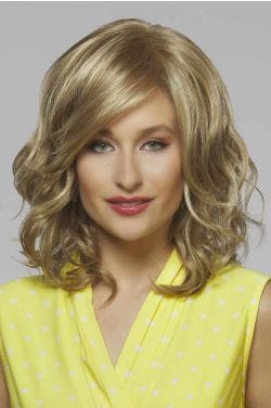 Woman in a chin length warm blonde curly wig with side bangs