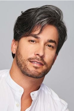 Man in a short salt and pepper lace front wig with longer layers on the top and sides