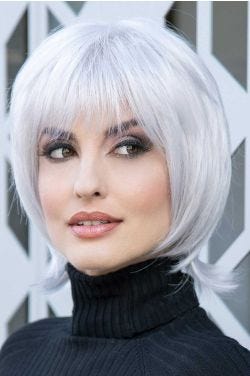 Woman in a past the chin silver layered bob wig with fringe bangs