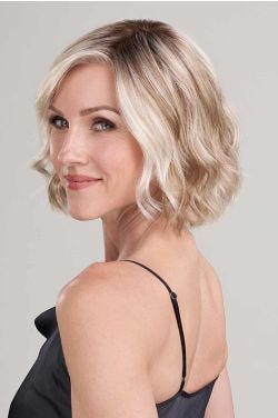 Woman in a chin length platinum blonde wavy wig