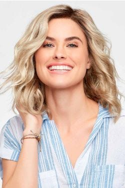 Woman in a petite shoulder length light blonde curly lace front wig
