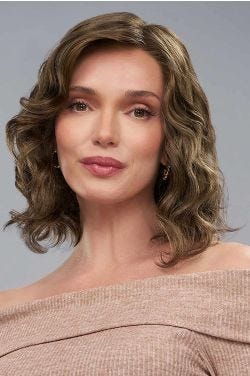 Woman in a shoulder length dark auburn curly lace front wig