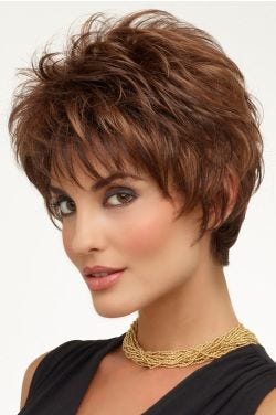Woman in a medium auburn shaggy pixie wig with textured bangs