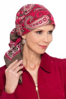 Woman in red hand stamped pre tied head scarf for cancer patients