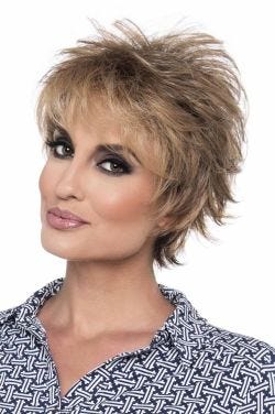 Woman in a short dark brown layered human hair wig with wispy bangs