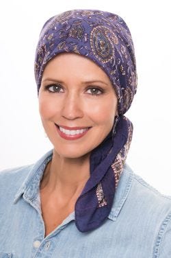 Woman in blue hand printed square cotton head scarf for cancer patients