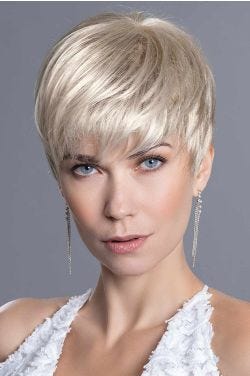 Woman in a light blonde pixie wig with longer layers on top