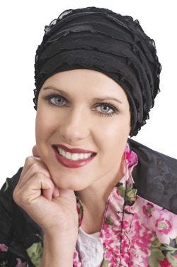 Woman in black sleeping cap with ruffled fabric for women with cancer