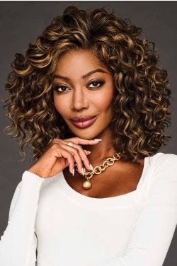 Black woman in a shoulder length ultra curly medium auburn wig