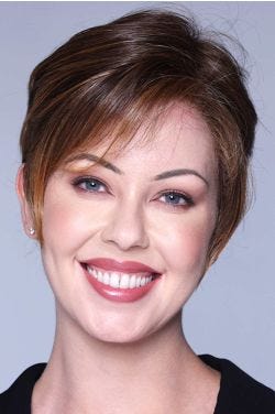 Woman in a short auburn lace front wig with wispy bangs
