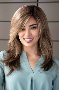 Woman in an extra long ash brown wig with long layers and curtain bangs