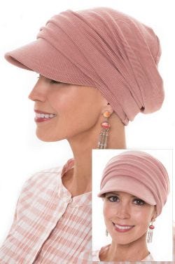 Woman in pink newsboy brimmed cancer hat with slouchy draping in back