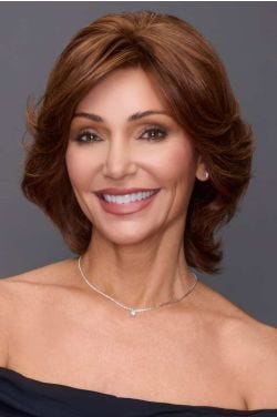 Woman in a medium auburn short and wavy shag wig with side swept bangs
